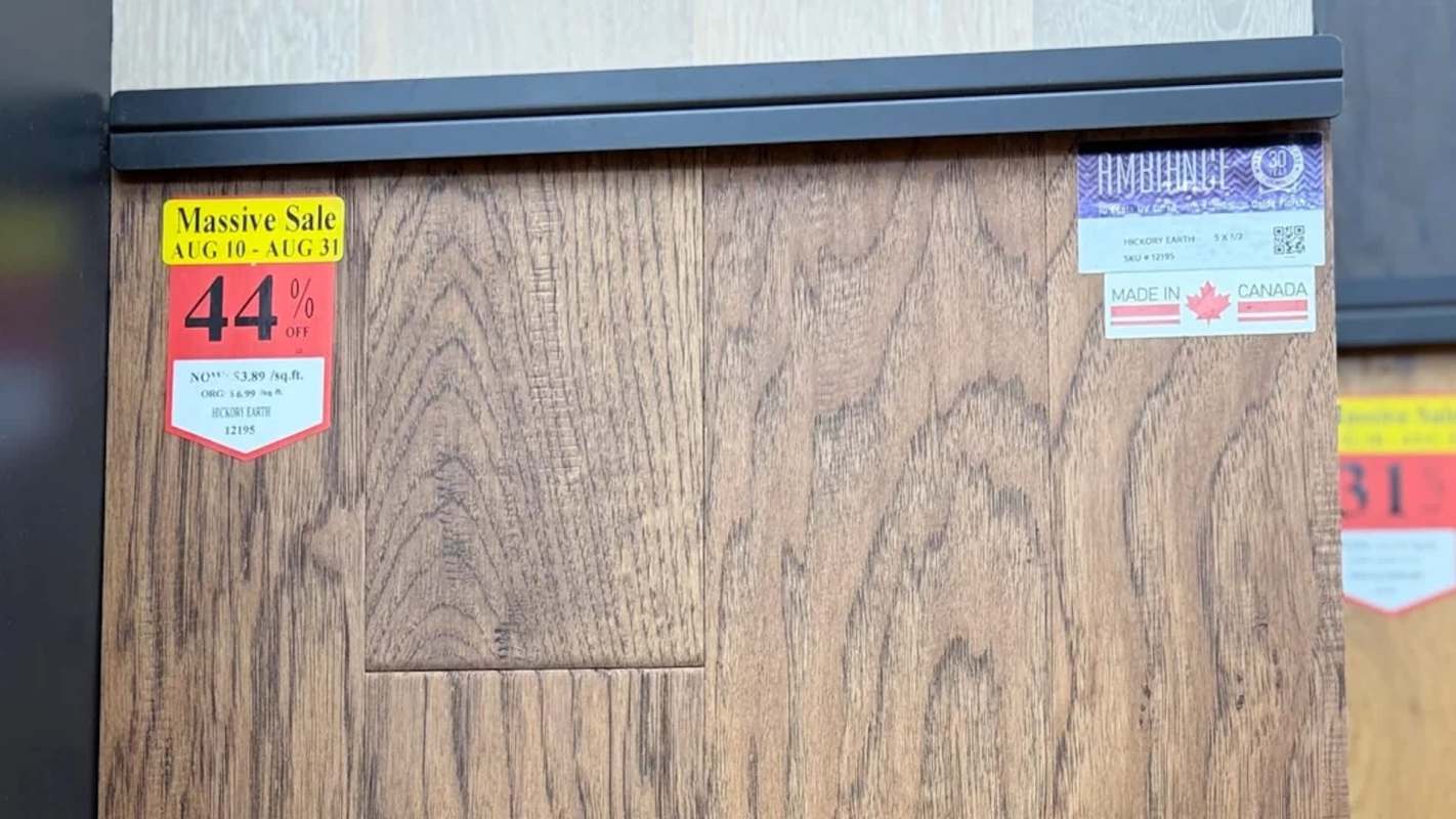 A wooden panel with sale stickers.