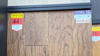 A wooden panel with sale stickers.