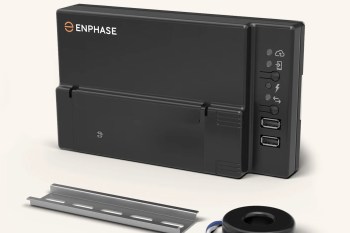 A black Enphase device with USB ports and LED indicator lights, accompanied by a metal mounting bracket and a circular component.