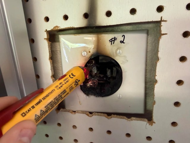 A person working on a melted outlet. 