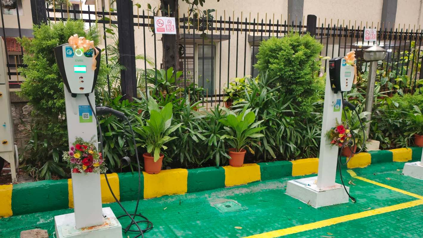 Two electric vehicle charging stations with ribbon bows.