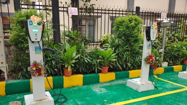 Two electric vehicle charging stations with ribbon bows.