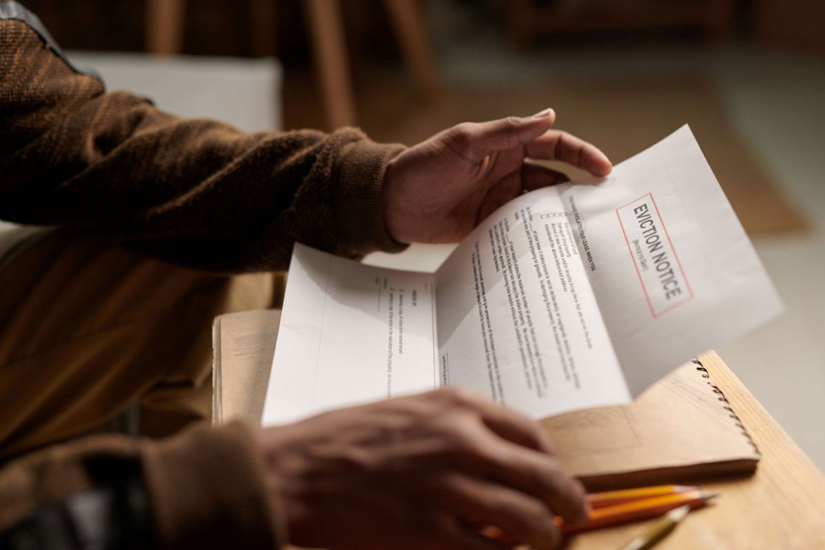 A person holding an eviction notice.