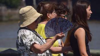 A group of people standing in the sun.