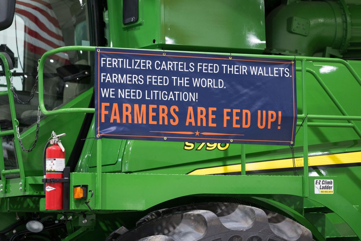 A sign in support of farmers on a tractor.