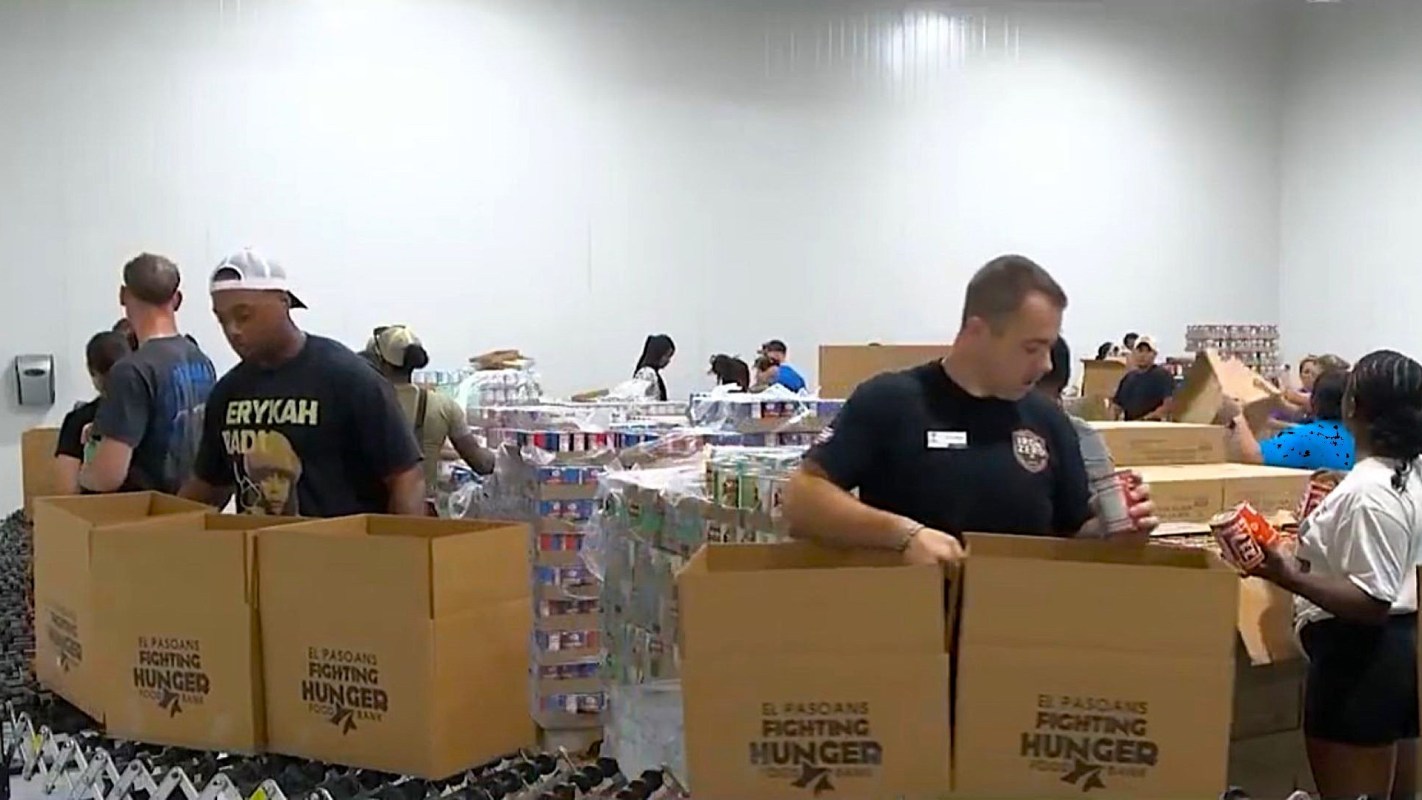 People packing boxes of food.
