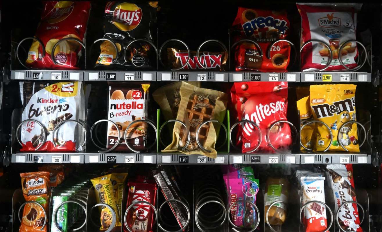A vending machine with chips and candy.