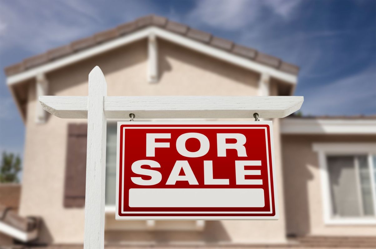 A "for sale" sign in front of a home.