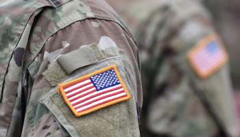 A military uniform with an American flag patch on the shoulder.
