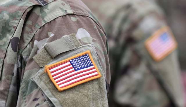 A military uniform with an American flag patch on the shoulder.