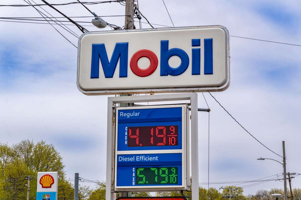 A Mobil gas station sign displaying fuel prices for regular and diesel.