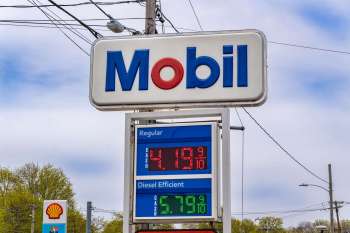 A Mobil gas station sign displaying fuel prices for regular and diesel.