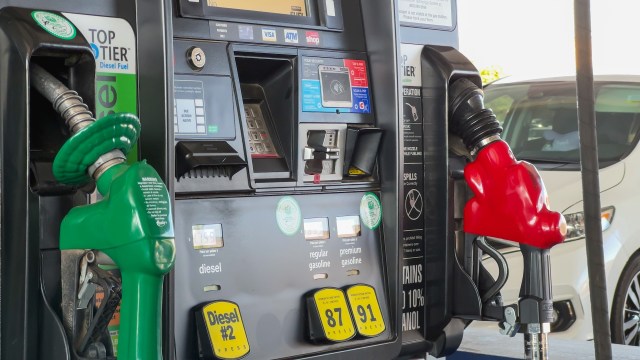 A fuel pump with green and red nozzles for diesel and gasoline options.
