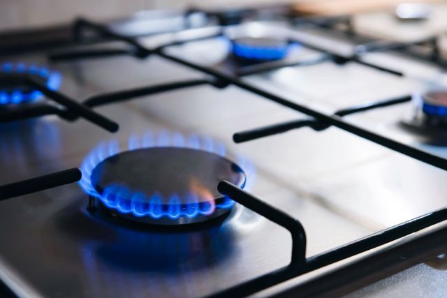 Lit burners on a gas stove.