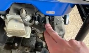 A hand touching a generator.