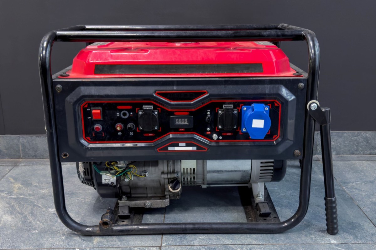 A red gas generator with knobs, wires, and switches