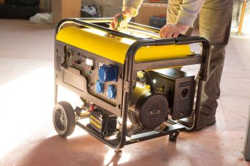 A person operating a generator.