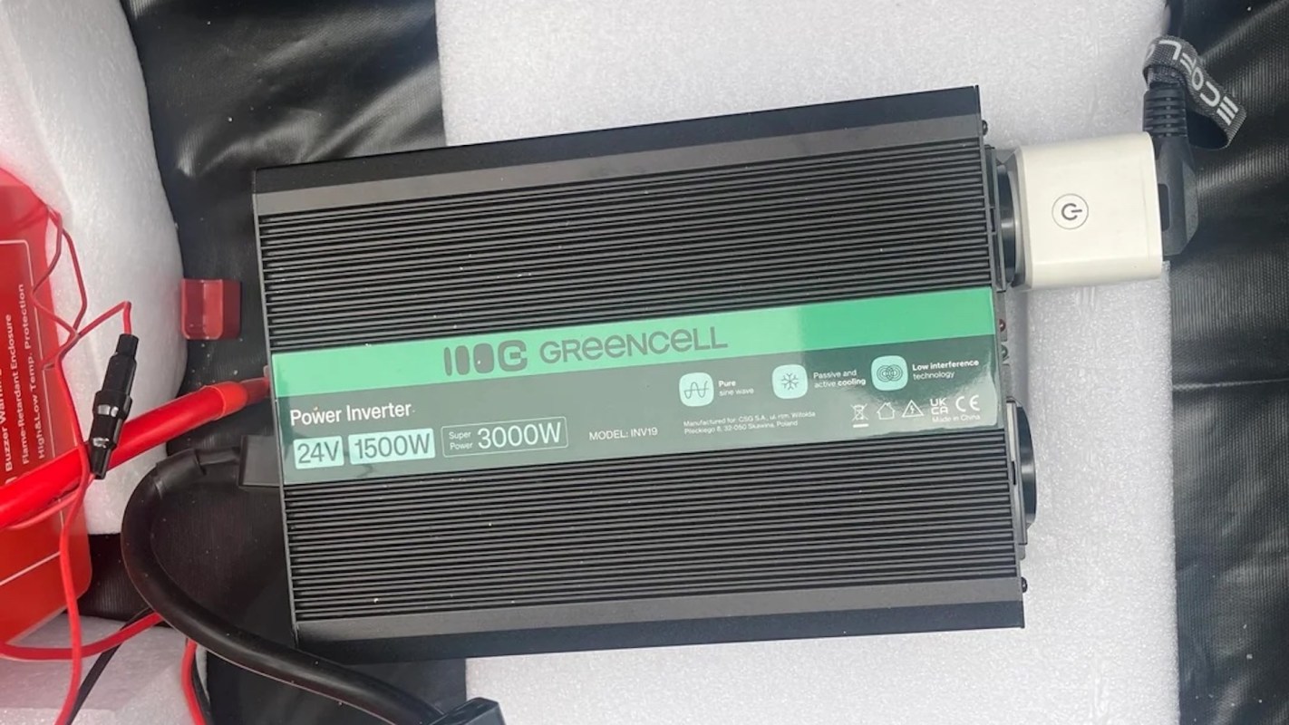 A power inverter with specifications 24V 1500W and 3000W, along with wires and connectors.