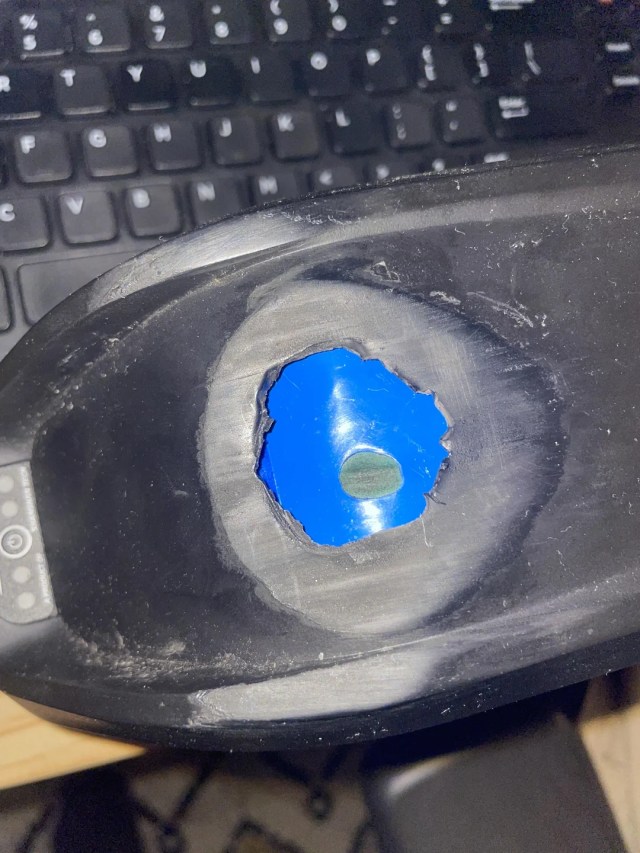 A battery pack with a large, deep hole in it.