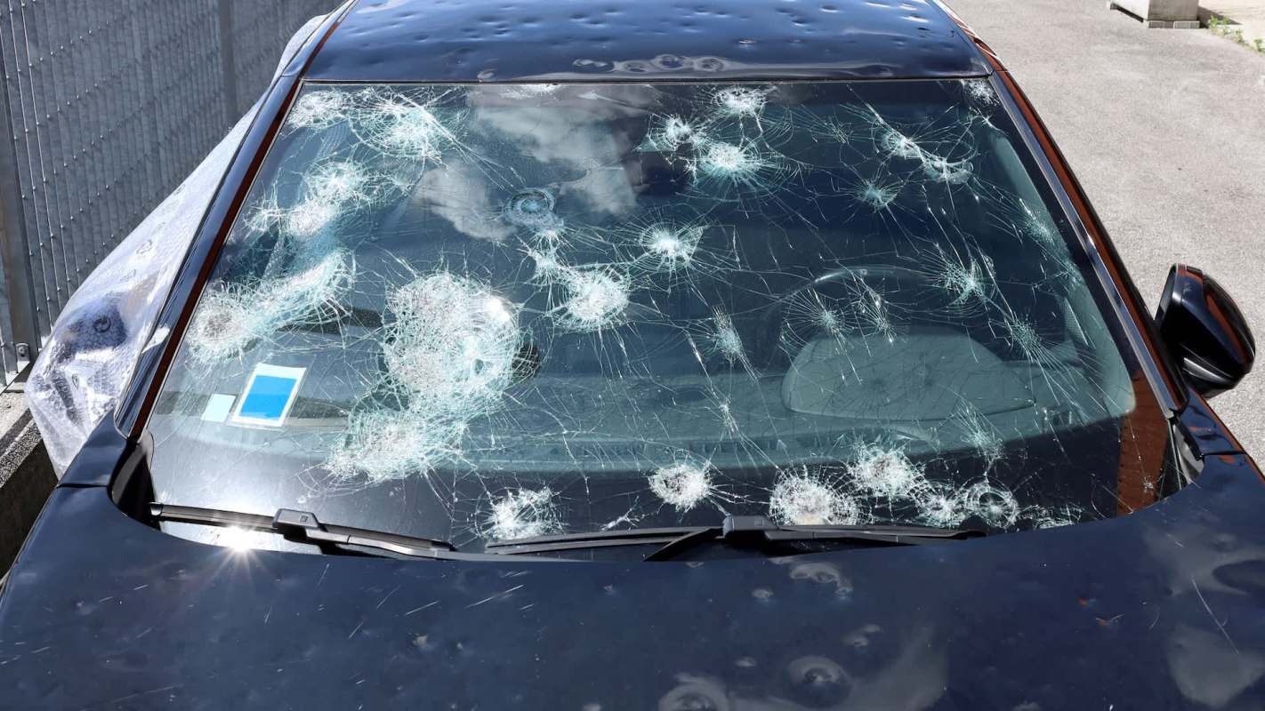 A car with a very damaged windshield.