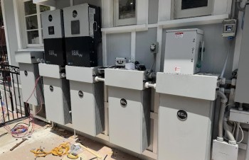 A series of electrical equipment and battery storage units mounted on a wall.