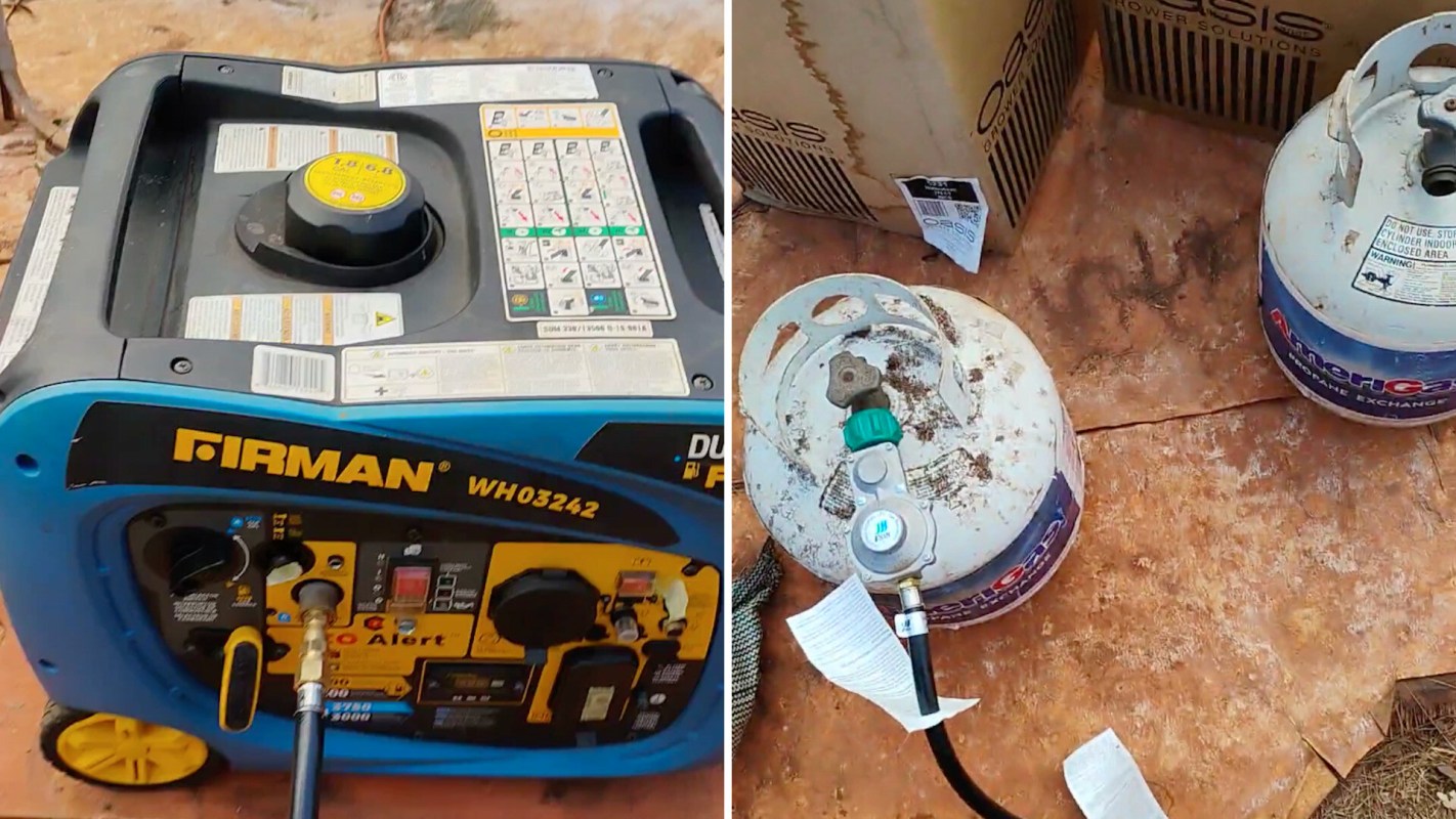 A generator and two propane tanks on a sandy surface.