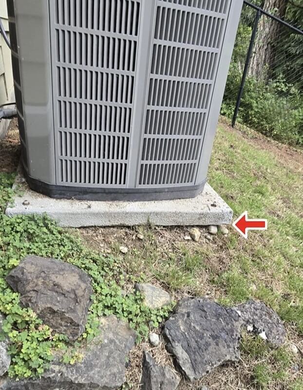 A heat pump on a pad.