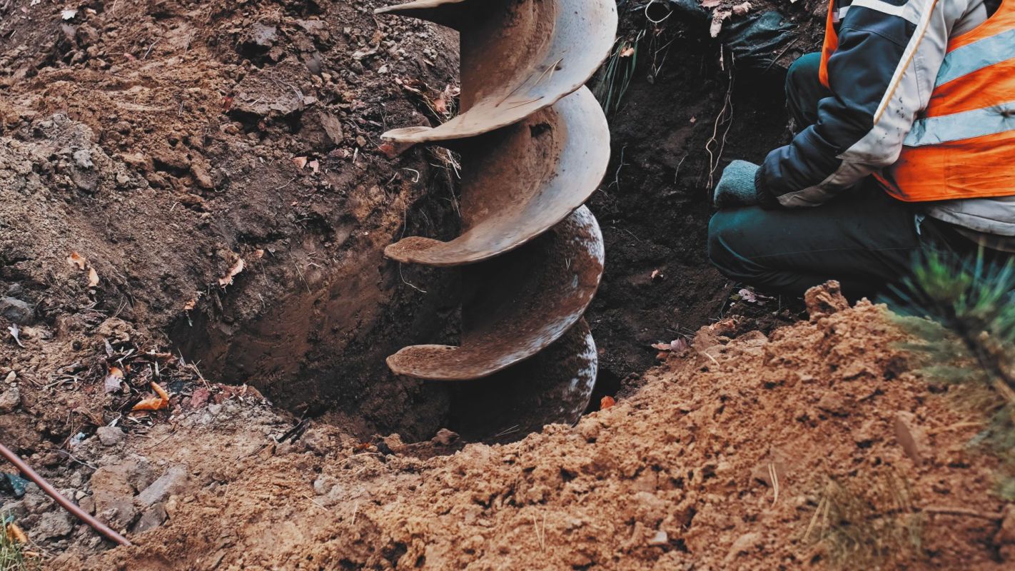 A construction worker drilling a hole.