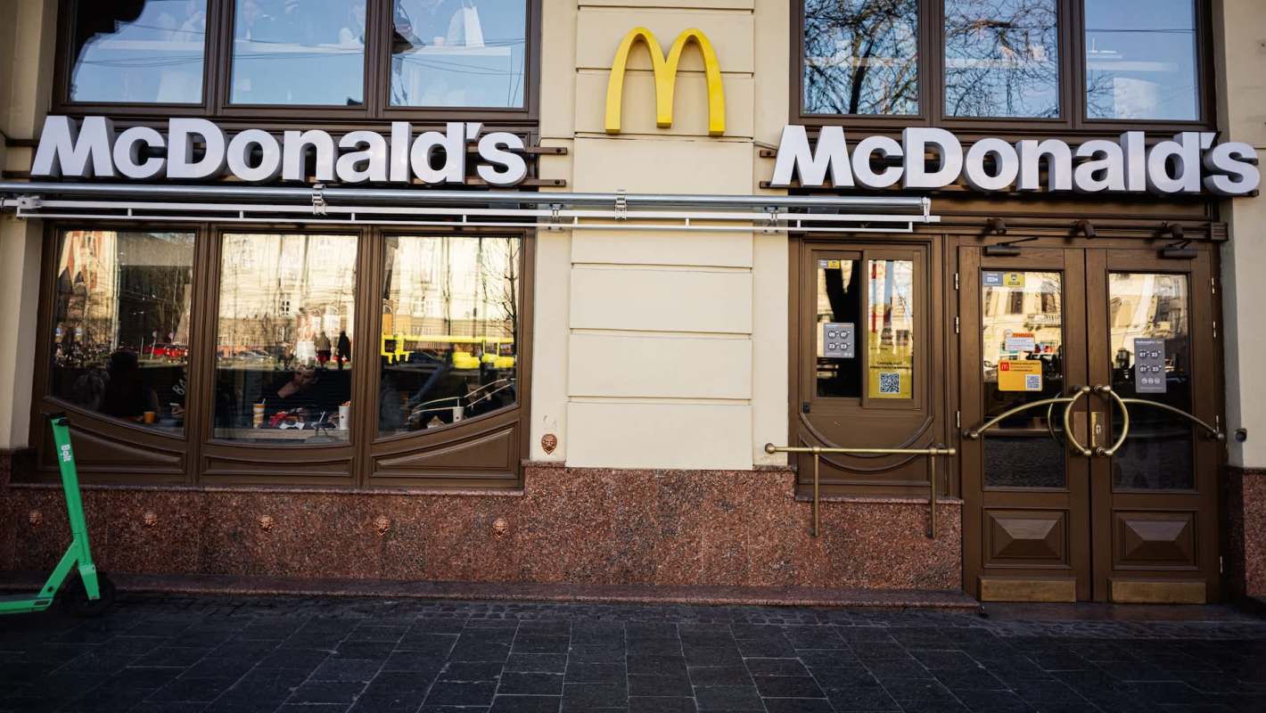 The exterior of a McDonald's restaurant with large signage and glass doors.