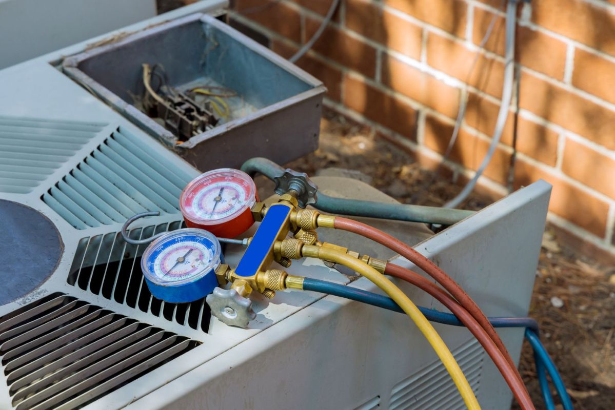 Technician tools sitting on top of an HVAC unit.