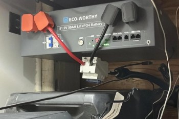 A gray battery labeled "ECO-WORTHY 51.2V 50AH LiFePO4" with various cables connected.