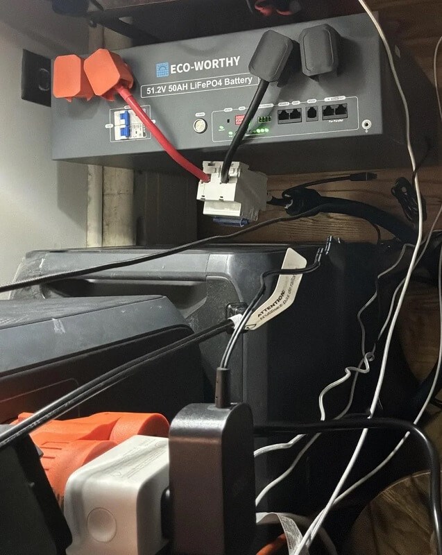 A gray battery labeled "ECO-WORTHY 51.2V 50AH LiFePO4" with various cables connected.