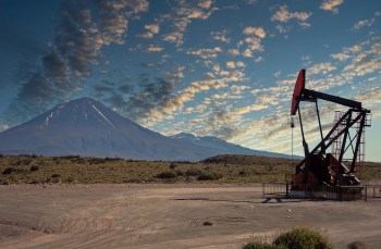 An oil pump near a mountain.