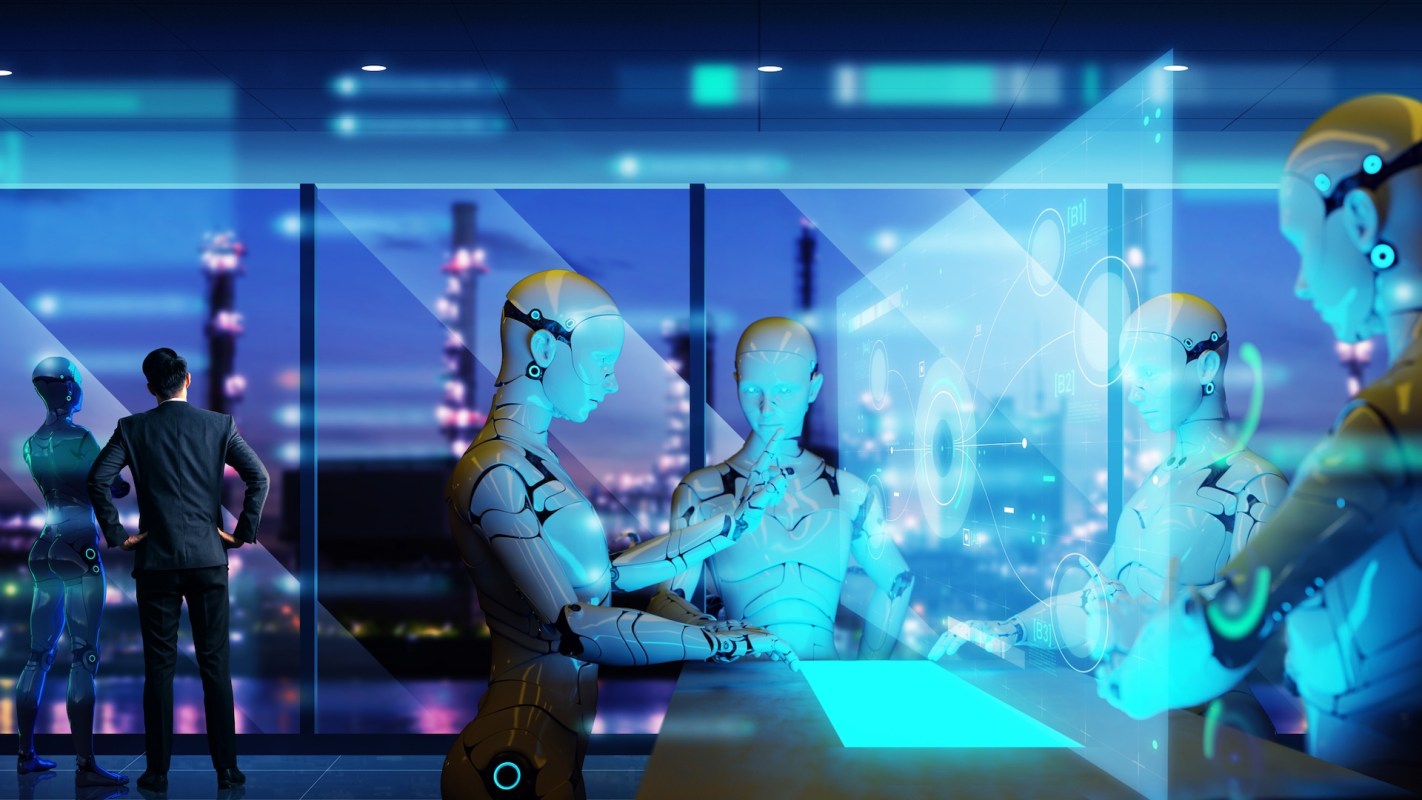 A man with two robots interacting with a digital interface in a high-tech environment.