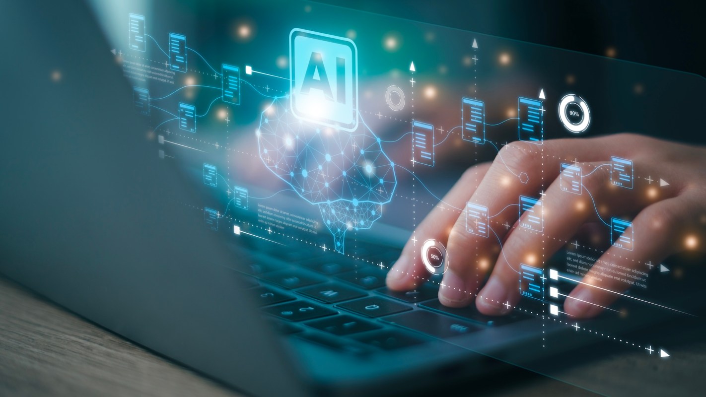 A person types on a laptop displaying digital representations of data and artificial intelligence concepts.