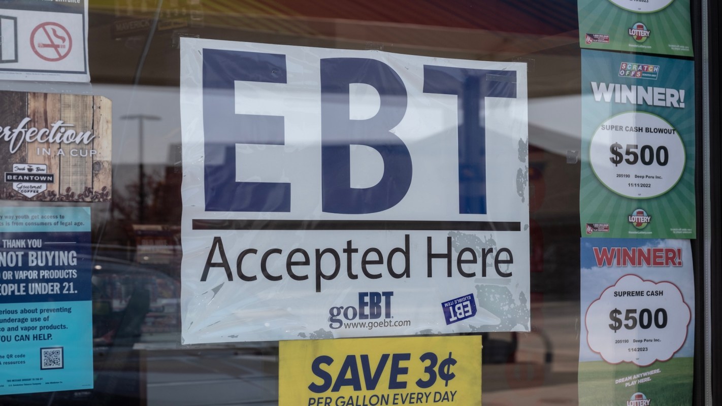 An "EBT Accepted Here" sign on a store window.