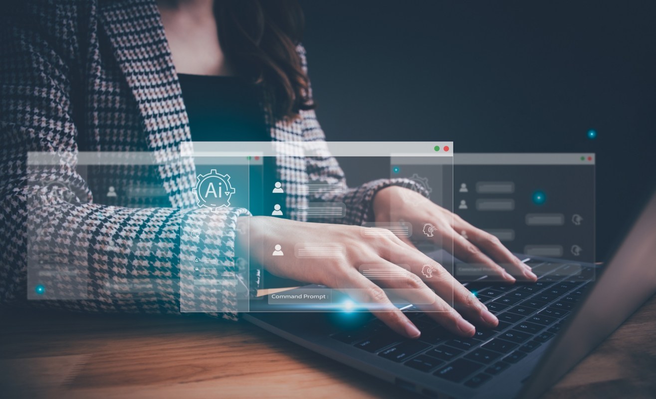 A woman types on a laptop surrounded by floating digital interface elements related to AI.