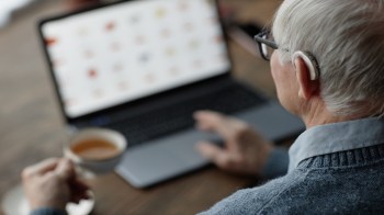 An older person using a laptop.