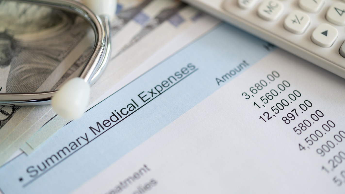 A stethoscope on a summary of medical expenses.