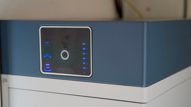 A control panel with blue LED indicators on a home battery storage device.