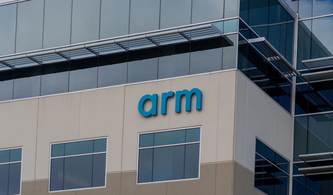The exterior of a modern building featuring the word "arm" in blue letters on a light-colored wall.