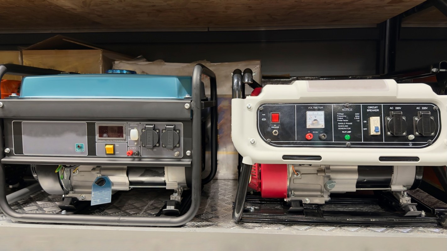 Two gasoline generators with displays and controls, positioned on a shelf in a storage area.