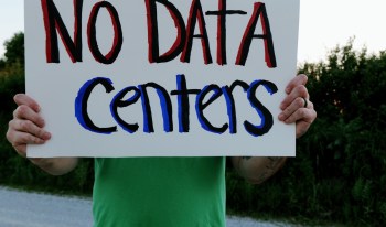 A person holding a sign that reads "NO DATA Centers."