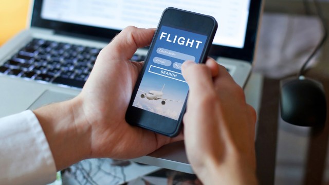 A person using a smartphone to search for flights.