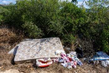 Discarded mattress and clothes.