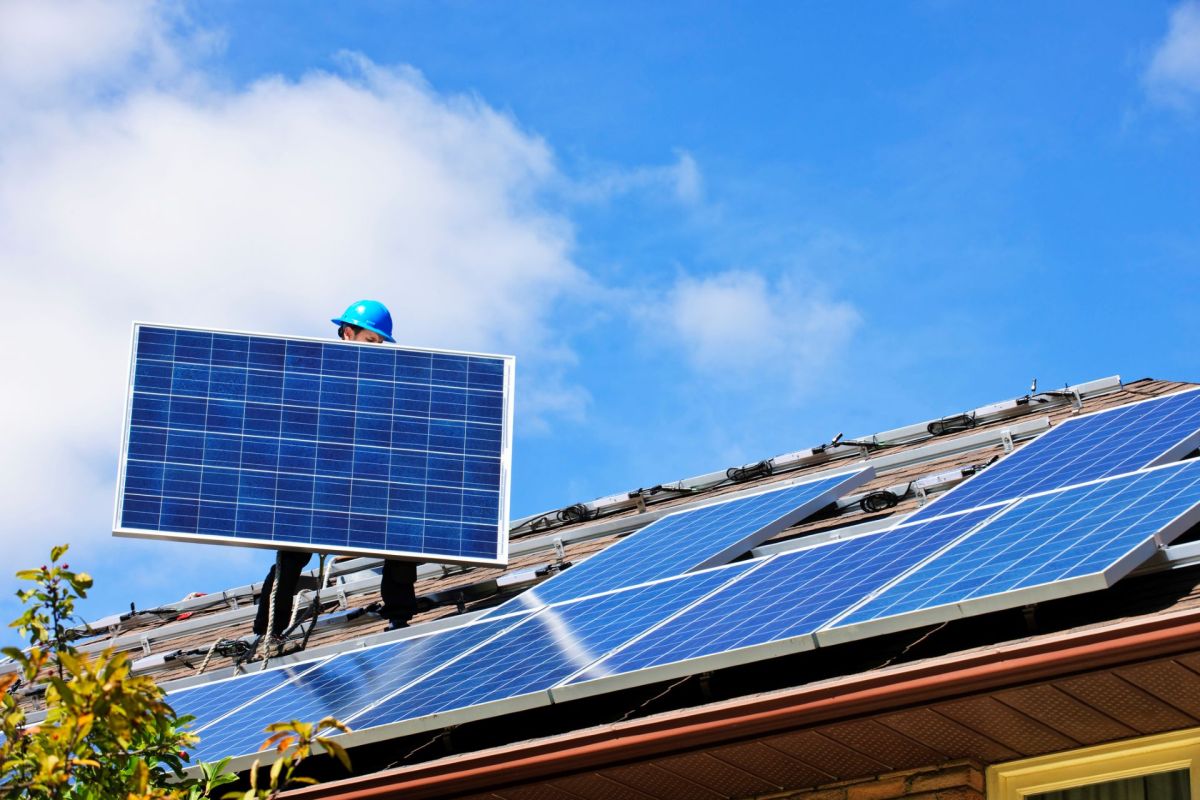 A person installing solar panels.