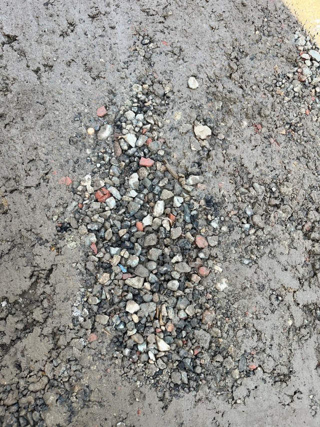 Gravel and concrete spread on the ground.