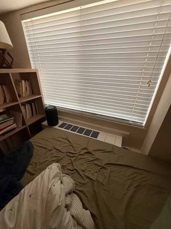 An AC vent under a window.