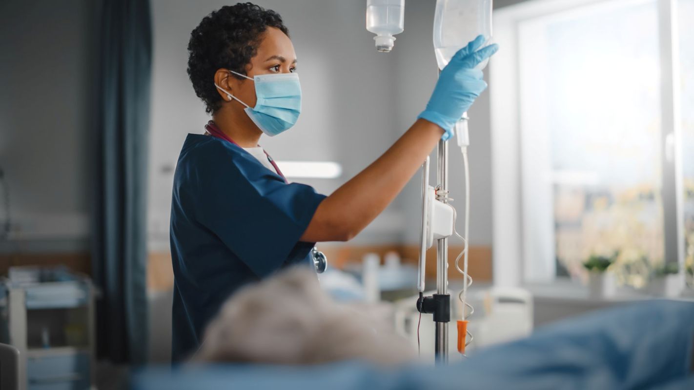 A nurse checking an IV bag.