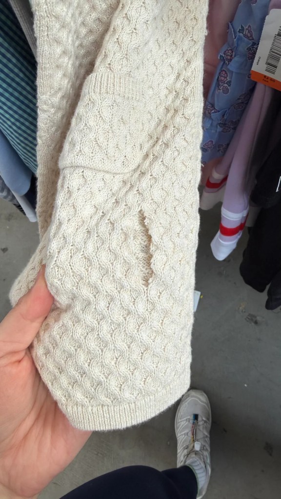 A knitted garment with holes in.